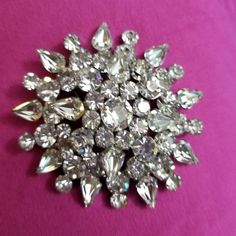 If you love jewelry, you will love this vintage glitzy crystal brooch which is probably from the 50's if not earlier.  It is a weighty, domed pin with clear round and pear shaped crystals that measures about 3 inches in diameter. These stones shine so much that it is hard to photograph them and the photos don't do them justice.  This pin is beautiful, and would look fabulous on a blazer, jacket or coat.        These are great for the vintage collector, or as a gift for someone who loves glitzy jewelry and is not afraid to be seen.  If you are shy, this pin is not for you, but if you love attention,  check out the other pins and brooches I have listed.  I guarantee that you will get noticed!   If you have any questions, please feel free to contact me and I will try to post more of my vintag Vintage Jewelry Ideas, Vintage Jewelry Antique, Shaped Crystals, Arlington Va, Beaded Lanyards, Cameo Jewelry, Love Jewelry, Antique Brooches, Brooch Vintage