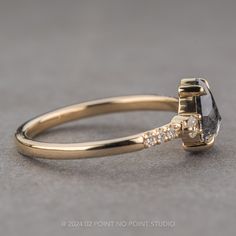 a yellow gold engagement ring with a black diamond