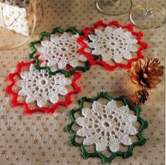 three crocheted doily are sitting on a table