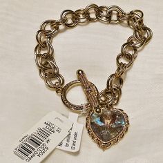 Add A Touch Of Vintage Charm Style To Your Collection With This Stunning 1928 Hearts Swarovski Charm Bracelet. This Bracelet Features A Beautiful Heart-Shaped Charm, Dipped In 14k Gold, And Suspended From A 7-Inch Gold Dipped Chain. This Bracelet Is Perfect For Adding A Pop Of Classic Style To Any Outfit. The Piece Is A Great Addition To Any Jewelry Collection And Is Suitable For All Occasion. Don't Miss Out On This Unique And Timeless Piece Of Jewelry. Beautiful Vintage! Awesome Collectors Addi Elegant Metal Heart Bracelet For Party, Elegant Heart-shaped Charm Bracelet For Party, Vintage Gold Heart Bracelet For Anniversary, Classic Metal Jewelry For Valentine's Day, Elegant Metal Heart Bracelet For Valentine's Day, Gold Metal Heart Bracelet For Wedding, Glamorous Gold Jewelry For Valentine's Day, Gold Metal Charm Bracelet For Anniversary, Elegant Gold-tone Bracelets For Valentine's Day