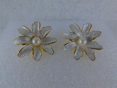 Stunning, shimmering silky smooth pearlized daisy bloom on a brilliant gold base w/textured backs. Earrings measure about 1 inch in diameter. Solid, well-made quality clip-on earrings....Pat. 196452 on the clip of each earring. Nearly pristine condition. White Flower-shaped Pearl Earrings For Formal Events, White Pearl Flower Earrings For Formal Occasion, White Floral Pearl Earrings For Formal Events, White Floral Pearl Earrings For Formal Occasions, White Pearl Earrings In Flower Shape For Formal Events, Formal White Flower-shaped Pearl Earrings, White Clip-on Flower Earrings, White Flower Clip-on Earrings, Formal White Clip-on Flower Earrings