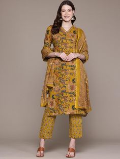 Floral Printed Embellished Pure Cotton Kurta with Trousers & Dupatta PRODUCT DETAILS  Mustard yellow, blue, and orange printed Kurta with trousers and dupatta Kurta design: Floral printed Straight shape Regular style V-neck Three-quarter regular sleeves Beads and stones detail Calf length length with straight hem Pure cotton machine weave fabric Palazzos design: Printed trousers Elasticated waistband with drawstring Slip-on closure Dupatta design: Printed dupatta Size & Fit The model (height 5'8 Yellow Anarkali Set With Kalamkari Print, Yellow Bollywood Style Floral Kurta, Yellow Cotton Salwar Kameez With Floral Print, Yellow Floral Print Kurta For Diwali, Yellow Floral Print Salwar Kameez For Navratri, Yellow Floral Salwar Kameez For Navratri, Yellow Floral Print Sets For Navratri, Yellow Floral Print Sets For Festivals, Festive Yellow Set With Printed Motifs