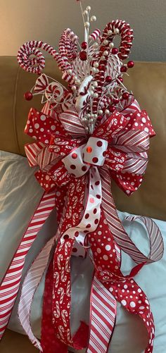 a red and white bow with candy canes on it