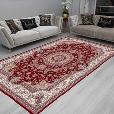 a living room with couches and rugs on the floor