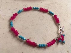 This bracelet created by Jewelry By Luet and Co is made of:  turquoise gemstones, hot pink jade gemstones, sterling silver:  beads, toggle and findings.  This bracelet measured 7 ½ inches in length.     To view more beaded bracelets:  http://www.etsy.com/shop/cdjali?section_id=7601186 All of our jewelry is unique and custom designed.  Most of our jewelry can easily be resized, so please do not hesitate to contact us.  If there is a piece of jewelry that you are interested in, but would like some Pink Jade, Sterling Silver Jewellery, Toggle Bracelet, Jewelry Sterling Silver, Jade Jewelry, Cute Bracelets, Turquoise Gemstone, Silver Jewellery, Silver Beads