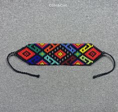 This beautiful beaded bracelet is hand-woven by the women of the Embera Chami Indigenous Tribe of Colombia Traditional Braided Bracelets With Colorful Beads For Festivals, Traditional Festival Braided Bracelets With Round Beads, Traditional Braided Bracelets With Round Beads For Festivals, Traditional Multicolor Beaded Braided Bracelets, Traditional Multicolor Braided Bracelets With Round Beads, Traditional Multicolor Hand-strung Braided Bracelets, Woven Beaded Friendship Bracelets For Festivals, Black Woven Beaded Bracelets For Festival, Bohemian Festival Bracelets With Rectangular Shape