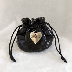 Vintage Guess Pouch. Store Your Jewelry In This Beautiful Pouch . Features Quilted, Patent Design, Drawstring Closure And A Silver Engraved Logo Heart Pendant. Approximate Measurements 5"(W) X 4"(H). Never Used Bags Guess, Logo Heart, Guess Bags, Engraved Logo, Cosmetic Bags, 4 H, Heart Pendant, Cosmetic Bag, Pouch