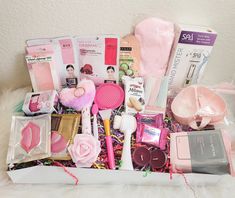 a box filled with lots of pink items on top of a white furnishing