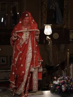 a woman in a red wedding dress and veil