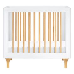 a white crib with wooden slats on the sides