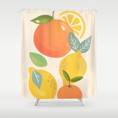 a shower curtain with oranges and lemons on the outside, in front of a white background