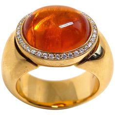 Thomas Leyser is renowned for his contemporary jewellery designs utilizing fine gemstones. This 18k rose gold ring (29.15g) is set with 1x fine Mandarine Garnet Cabouchon (oval, 14x12mm, 12.15ct) + 36x Diamonds (brillant-cut, 1mm, G/VS). Ringsize 7.5 (56). Rose Gold Cufflinks, Garnet And Diamond Ring, Contemporary Jewelry Design, Gold Cufflinks, Contemporary Jewellery, Jewellery Designs, Cocktail Rings, Solitaire Ring, 18k Rose Gold