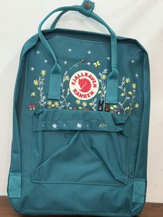 The product you received is an embroidered Kanken backpack The backpack is produced and used in Vietnam market  Actual color may be slightly different due to phone light The package you receive includes backpack and hand-embroidered design as shown. Please read the information carefully to choose the color you want for Version & Size: Version & Size - Kanken No.1: This is the classic (original) version with 3 sizes + Mini size: 29x20x13cm (A5 paper size) + Medium size: 27x38x13cm (laptop 15 inch size) + Large size: 35x45x15cm (laptop 17 inch size) => For the Large size, there are just few color choices so Please look carefully at the color description photo. - Kanken No.2: This is the version with leather straps + Mini size: 29x20x13cm (A5 paper size) + Medium size: 27x38x13cm (laptop 14 i Vietnam Market, Embroidered Kanken, Phone Light, Backpack Gift, Embroidered Bag, Flower Embroidery, Kanken Backpack, Backpack Purse, Embroidered Design