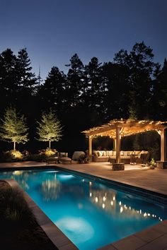 Backyard pool illuminated with soft lighting, creating a serene and inviting nighttime atmosphere. Swimming Pool Lighting Ideas, Pool Lighting Ideas, Underwater Pool Light, Pool Lighting, Perimeter Lighting, Outdoor Lighting Ideas, Floating Lanterns, Pool Lights