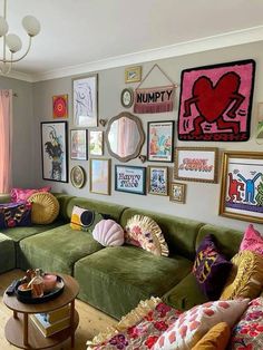 a living room filled with lots of furniture and pictures on the wall above it's couches