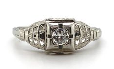 All of our jewelry is guaranteed authentic by our Graduate Gemologist of the Gemological Institute of America (GIA). 18k White Gold Filigree Genuine Natural Diamond Ring Chevron Like Design #J5946 Art Deco 18k white gold diamond filigree ring. The diamond is European cut and weighs about .10cts. The ring fits a size 7 1/2 finger, weighs 1.13 dwt., and dates from the 1920s. Wonderful! SKU#J5946. 100% Satisfaction Guaranteed! Elegant Engraved Diamond Ring For Formal Occasions, Engraved White Gold Filigree Ring, Elegant Engraved White Diamond Ring, Elegant Diamond Filigree Ring With Engraving, Elegant Engraved Diamond Filigree Ring, Formal Engraved Filigree Ring With Round Cut, Luxury Formal Filigree Ring With Single Cut Diamonds, Luxury White Gold Filigree Ring For Formal Occasions, Luxury White Gold Filigree Ring For Formal Events