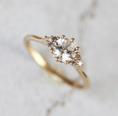 a gold ring with two diamonds on it