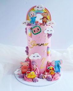 a pink cake with animals on it and the words summer written in white writing below