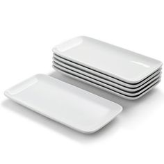 four white plates stacked on top of each other