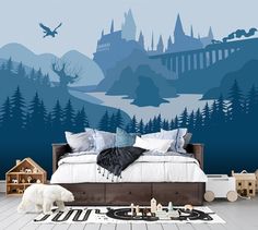 a bedroom decorated in blue and white with an image of hogwart's castle on the wall