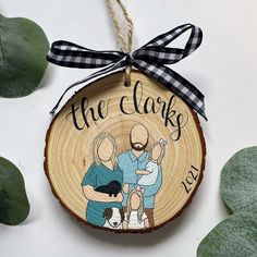 a wooden ornament with an image of two people and a dog on it