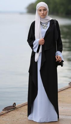 Introducing Annah Hariri's Exquisite Abaya Dress - a perfect blend of tradition and modern elegance in Blue & Black. Designed with impeccable craftsmanship, versatility, and adaptability, this dress celebrates the beauty and grace of the wearer. Available as a kimono abaya or elegantly designed eid abaya, it is a treasure in your wardrobe for any occasion. Experience unmatched elegance with Annah Hariri. HN022 Islamic Clothing Women, Annah Hariri, Eid Abaya, Abaya Dresses, Pink Heart Dress, Abaya Kimono, Black Elegance, Cherry Dress, Muslim Outfits