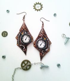 Steampunk Cooper Earrings Figured Intrigue. Unique handmade steampunk jewelry These unusual earrings will be perfect interesting detail of your look. They are made of polymer clay, glass drops, watch parts and painted with acrylic paint. All details are handcrafted. These Figured earrings are covered with gloss varnish for better protection and hanging on a cooper tone steel settings.   ♦ Size Steampunk earrings are 8.5 cm (3.4'') long including wire and 3 cm (1.3 '') wide.         Attention!                Please use this product with care, cannot go in contact with water and dissolvent.              Real colors may slightly differ from their appearance on your display, as it depends on your monitor settings and is not under my control.  Comes safety and uniquely gift wrapped! AVAILABLE f Cooper Earrings, Polymer Clay Steampunk, Steampunk Hairstyles, Aluminum Earrings, Clay Works, Steampunk Earrings, Steam Punk Jewelry, Steampunk Accessories, Unusual Earrings