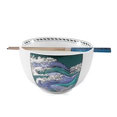 a bowl with chopsticks in it sitting next to an object that looks like waves