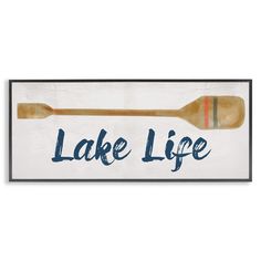 a wooden sign that says lake life with two paddles