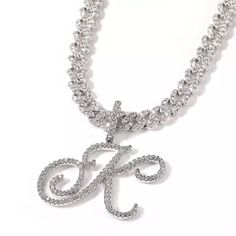 Express yourself with this icy cursive script capital initial letter pendant poised on a vibrant 9mm Cuban Link chain. This is the perfect gift for holiday, birthday, anniversary, graduation parties and more. Wear it for any occasion. Available in gold or platinum plating. 16” or 18” Cuban Link Chain with AAA Zircon Stones 18k Gold or Platinum Electroplated Brass Chain Base Metal Stones individually set with micro insert inlay technology Water and Tarnish Resistant with proper care PREORDER - Th Luxury Gold Chain Jewelry With Cubic Zirconia, Diamond Cuban Link Chain, Bling Gifts, Initial Necklace Silver, Hip Hop Bling, Script Initial, Cuban Link Necklace, Cursive Script, Tennis Chain