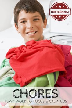 a young boy is smiling while holding clothes in front of him and the words, chores heavy work to focus & calm kids