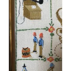 a close up of a cross stitch pattern on a piece of cloth with pictures of people and animals