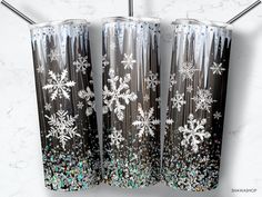 three snowflakes on black and silver glittered tumbler cups with straws