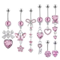 several different types of belly piercings with pink crystal hearts and bows on them,