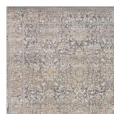 an antique rug with many different colors and patterns on the carpet, including greys