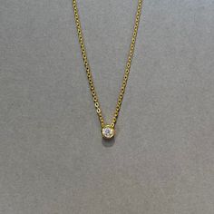 Our bezel solitaire necklace is available in sterling silver or 14KT gold vermeil. Materials: 925 sterling silver or 14KT gold vermeil Vermeil: 14KT yellow gold plating over 925 sterling silver Gemstone: Cubic Zirconia Closure: Spring ring Length: Adjustable length 16" to 18" Follow us on Instagram @pennyweightsjewelry Follow us on Facebook @facebook.com/pennyweights Follow us on Pinterest @pennyweights Click on the links at the bottom left of this page! Classic Yellow Gold Solitaire Necklace For Everyday, Everyday Gold-plated Jewelry With Bezel Setting, Everyday Gold Plated Jewelry With Bezel Setting, Minimalist Yellow Gold Solitaire Necklace, Dainty Gold Jewelry With Bezel Setting, Yellow Gold Jewelry With Single Diamond, Minimalist Gold Solitaire Necklace With Round Stone, Gold Solitaire Necklace With Round Stone For Formal Occasions, 14k Gold Solitaire Necklace For Everyday