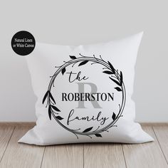 the robertson family personalized pillow on a wooden floor with a black and white background