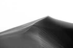 a black and white photo of the top of a sand dune