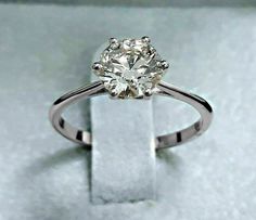 a diamond ring sitting on top of a white box