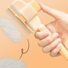 a person is holding a comb with hair on it and the other hand is pointing at it