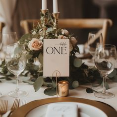 the table is set with candles, plates and napkins for an elegant wedding reception