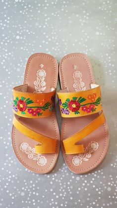 Mexican Sandals are made with soft insole and durable outsole. Rubber sole for comfortable walking! Strips are made with leather and decor with mexican embroidered. Huaraches are perfect as Summer shoes. They are unique and original. Easy to wear with jeans, dresses and shorts. *Need special size? - Please send a message, gladly assit you! We have more designs *In wholesale special prices! (Remember that because are made of leather it is required to use them to fit them) Shipping: Ready to ship Orange Single Toe Strap Sandals For Spring, Yellow Bohemian Sandals With Round Toe, Yellow Bohemian Round Toe Sandals, Yellow Bohemian Leather Sandals, Bohemian Yellow Leather Sandals, Bohemian Yellow Sandals For Spring, Yellow Leather Bohemian Sandals, Floral Embroidered Round Toe Sandals For Beach, Traditional Closed Toe Sandals With Floral Embroidery