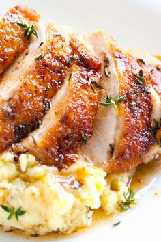 chicken breast with mashed potatoes and herbs on a white plate text reads easy pan roasted