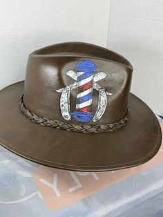 Barber Hat Fedora Sombrero Brown Leather Brown Leather Fedora Hat, Custom Brown Fedora With Curved Brim, Leather Flat Crown Country Hat, Country Style Leather Hat With Flat Crown, Brown Leather Top Hat With Curved Brim, Brown Leather Wide Brim Top Hat, Custom Brown Fedora With Flat Brim, Custom Brown Brimmed Fedora, Leather Fedora With Flat Crown For Rodeo