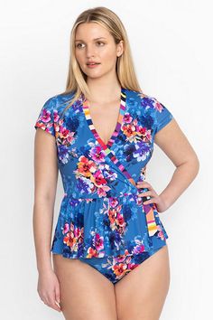 Crafted from a lightweight, quick-drying material, the Summer Days Mix Wrap Tankini Top offers elevated style embellished with brilliant floral bouquets. Featuring a wrap-front closure and cap sleeves, this unique swim top is finished with a fluttering peplum skirt for a distinctly feminine silhouette. Pair with the Summer Days Bikini bottoms and layer with white linen palazzo pants to go from poolside to brunch in style. Johnny Was Women's Summer Days Mix Wrap Tankini Top in Summer Days (Blue), Printed Fitted Short Sleeve Swimwear, Fitted Short Sleeve Printed Swimwear, Floral Print V-neck Beachwear Top, Upf 50+ Short Sleeve Beachwear Tops, Upf 50+ Short Sleeve Beach Tops, Fitted Floral Print Top For Poolside, Blue Printed Short Sleeve Swimwear, Fitted Short Sleeve Beachwear Top, Fitted Tops With Upf 50+ For Summer