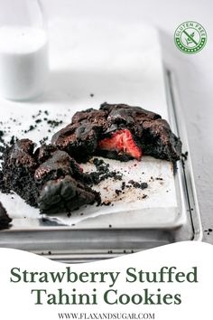 strawberry stuffed tahitii cookies on a plate with milk in the background and text overlay