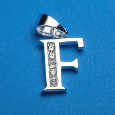 the letter f is made up of silver and has three diamonds on each one side