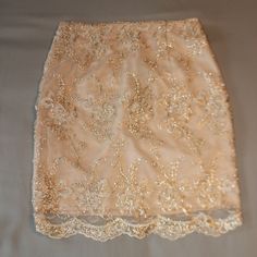 Romeo And Juliet Couture Champagne Colored Skirt With Gold Embroidered Embellishments, Zipper And Hook In Back, Size X-Small, Nwt Waist 12”, Length 17.5” (Laying Flat). Shell 100% Nylon, Lining And Embroidery Thread 100% Polyester. Hand Wash And Lay Flat To Dry. Skirt Hits Above The Knee For Me (I'm 5'). Embroidered Embellishments, Couture Skirts, Embroidery Threads, Gold Embroidery, Champagne Color, Romeo And Juliet, Cream And Gold, White Skirts, Above The Knee