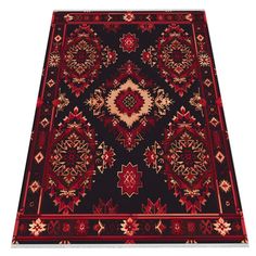 a red and black rug with an intricate design on the bottom, in front of a white background