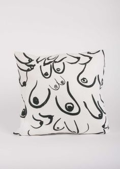 a black and white pillow with an animal design on the front, sitting against a white background